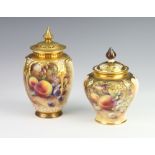 A Royal Worcester oviform vase decorated with fruits indistinctly signed with a reticulated lid (