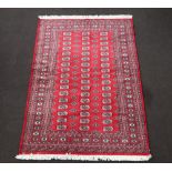 A red and blue ground Bokhara rug with 51 octagons to the centre 228cm x 153cm