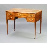 An Edwardian bleached and inlaid mahogany bow front writing table with brown leather inset writing