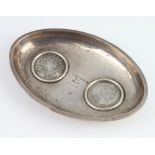 A Continental white metal double coin set oval dish 112 grams, 14.5cm