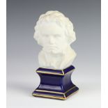 A 20th Century Limoges bisque porcelain bust of Beethoven, raised on a blue and gilt glazed plinth