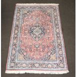 A North West Persian pink, white and blue ground silk rug with central medallion 203cm x 134cm