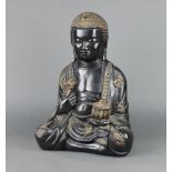 A black painted plaster figure of a seated Buddha 48cm x 35cm x 20cm together with an associated