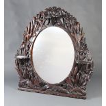 A Victorian oval plate over mantel mirror contained in a carved and pierced mahogany frame, carved