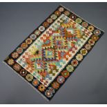 A white, black and green ground Chobi Kilim rug with geometric designs 153cm x 100cm