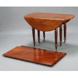 A Victorian oval drop flap extending dining table, raised on 6 turned and fluted supports with 2