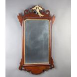A Chippendale style rectangular plate wall mirror contained in a walnut frame surmounted by a