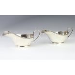 A pair of silver Art Deco sauce boats with scroll handles, Sheffield 1932, 296 grams