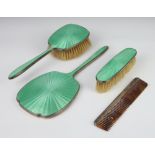 A silver and green guilloche enamel dressing table set comprising hand mirror, clothes brush, hair