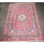 A blue and red ground North West Persian carpet with central medallion 434cm x 313cm Some wear in