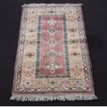 A Turkish Caucasian style pale yellow and green ground rug with 4 diamonds to the centre 190cm x