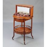 Albert Baker, an Edwardian mahogany circular 2 tier drinks table, the upper section having a