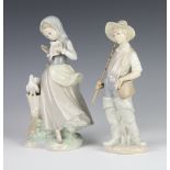 A Lladro figure of a boy fisherman 22cm, a ditto of a girl holding a dove 21cm