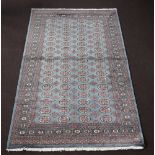 A blue ground Bokhara rug with 68 octagons to the centre 244cm x 152cm