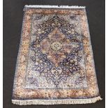 A North West Persian blue and white ground silk rug with central medallion 182cm x 123cm This rug