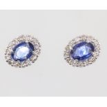 A pair of white metal 18ct oval sapphire and diamond ear studs, the sapphires 1.52ct, the