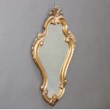 A Rococo style shaped plate wall mirror contained in a gilt painted frame 54cm h x 32cm