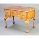 A 1920's Queen Anne style quarter veneered walnut and crossbanded low boy with canted corners,