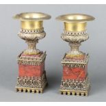 A pair of Victorian gilt bronze urns raised on pink hardstone bases 26cm h x 13cm