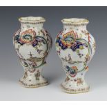 A pair of Delft polychrome vases decorated with scenes of windmills and boats 24cm