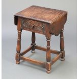 An Ipswich style carved oak drop flap occasional table fitted a frieze drawer, raised on turned