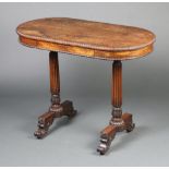 A William IV oval rosewood writing table fitted a drawer, raised on turned and reeded supports