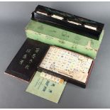 A 152 piece bone and bamboo mahjong set contained in a pine box with sliding lid, together with 4