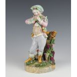 An early 20th Century Meissen figure of a standing youth beside a grapevine 13cm There are minor