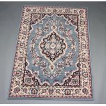 A blue and black ground Persian style machine made rug with central medallion 167cm x 120cm