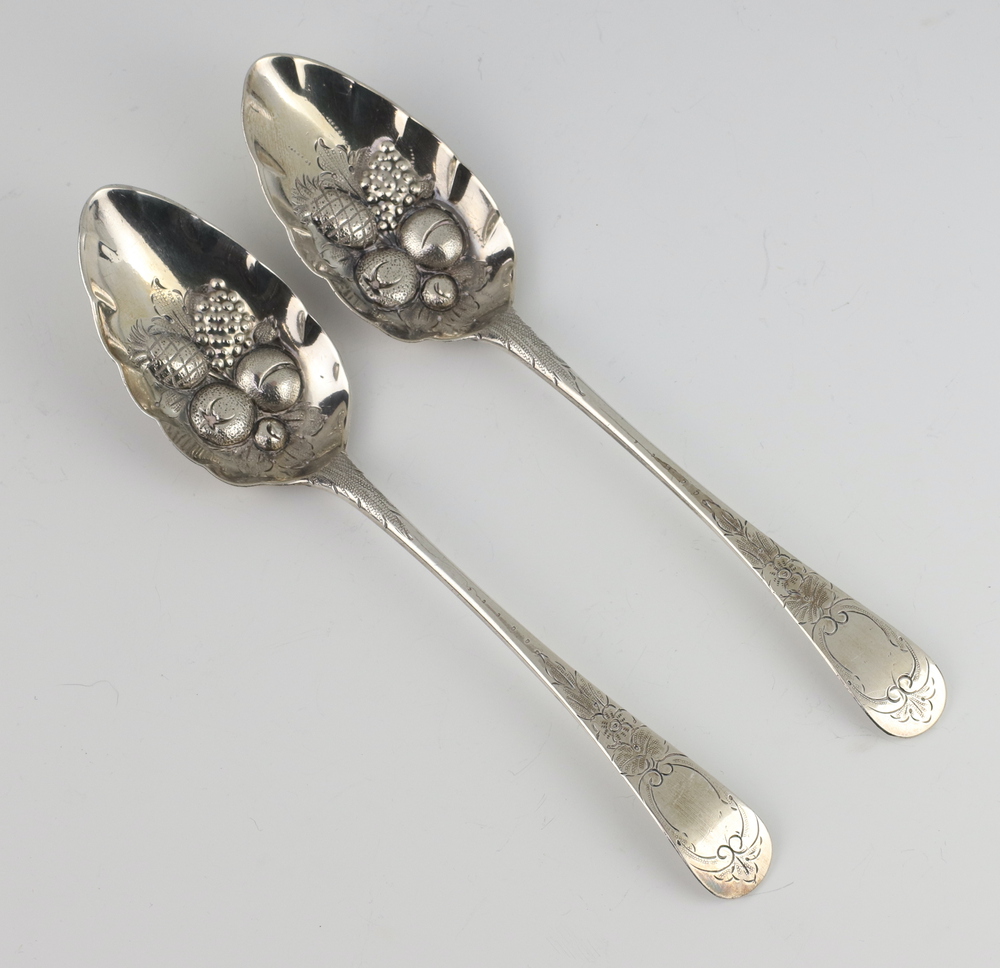 A pair of Georgian silver berry spoons with engraved decoration (rubbed marks) 138 grams