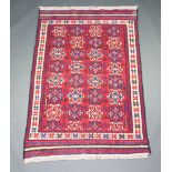 A red, white and blue flat ground Kilim rug with all over geometric design 214cm x 139cm