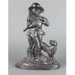 A Victorian style cast iron door stop of a sanding woodsman with dog on an oval base 33cm x 23cm x