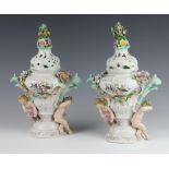 A pair of early 20th Century Meissen 2 handled vases and covers with floral decoration and cavorting