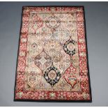 A black, tan and gold ground Persian style machine made rug 167cm x 107cm