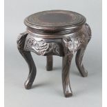 A circular Chinese carved hardwood jardiniere stand raised on cabriole supports 39cm h x 24cm