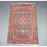 A blue and red ground North West Persian rug with central medallion within multirow border 160cm x