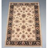 A brown and black ground Persian style machine made rug with floral design to the centre 180cm x