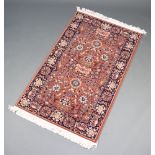 A tan and black ground Persian style machine made rug 152cm x 91cm