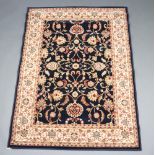 A black and gold ground Persian style machine made rug 169cm x 121cm
