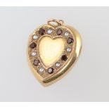 A 9ct yellow gold garnet and pearl heart locket 3.8 grams, 20mm