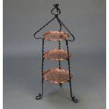 A Victorian Art Nouveau embossed copper and wrought iron circular 2 tier graduated cake stand 90cm h
