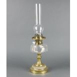 A Victorian panel cut glass oil lamp reservoir with brass fittings marked Evered and Co. complete