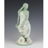 A Victorian Minton glazed and bisque figure of a semi-clad lady sitting before a shell 39cm There is