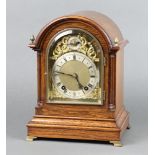 A German Edwardian striking bracket clock, striking on 2 gongs, with arched gilt dial, silver