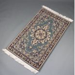 A blue and white ground Persian style machine made rug 150cm x 91cm