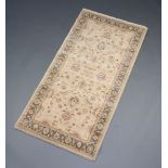 A gold ground and floral patterned Persian style rug 158cm x 80cm
