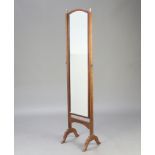 A 1930's arched plate cheval mirror contained in a mahogany swing frame with brass finials, 161cm