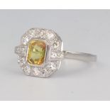 A yellow metal stamped 750 yellow sapphire and diamond Art Deco style ring, the centre stone 1.