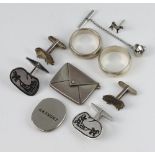 A silver stamp holder in the shape of an envelope, 2 pairs of silver cufflinks, 2 rings and a