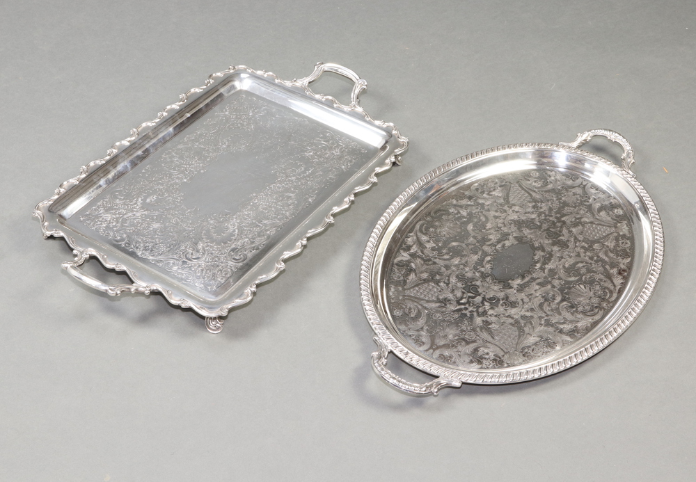 An oval silver plated 2 handled tray with engraved decoration 66cm, a rectangular ditto 64cm